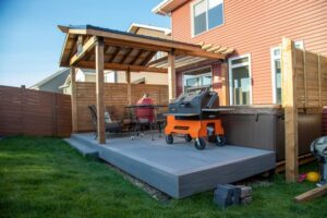 Prestige Woodworks - Christian Neudecker - Deck Builder - Fiberon Goodlife Line Colour Beachhouse - Pressure Treated Covered Deck with Gabled Roof with Eavestrough System - Ozco Pergola Hardware - Wood Screen - Outdoor Light Fixture with Indoor Light Switch - Landscaping - 4