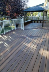 Prestige Woodworks - Christian Neudecker - Deck Builder - 2 Tiered Composite Deck, Double Boarded Fiberon Horizon Line Colour Cinnabar, Main is Fiberon Horizon Line in Colour Ike - Compass is in Fiberon Horizon Line in Colours Tudor Brown and Cinnabar - Border is face screwed and colour matched plugs - Fully Customized Railing System - 4 Custom Staircases - Customized Bench fully Clad in Matching Composite Boarded in Cinnabar to match deck with Covered matching Fascia Boards on Bases