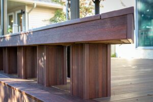 Prestige Woodworks - Christian Neudecker - Deck Builder - 2 Tiered Composite Deck, Double Boarded Fiberon Horizon Line Colour Cinnabar, Main is Fiberon Horizon Line in Colour Ike - Compass is in Fiberon Horizon Line in Colours Tudor Brown and Cinnabar - Border is face screwed and colour matched plugs - Fully Customized Railing System - 4 Custom Staircases - Customized Bench fully Clad in Matching Composite Boarded in Cinnabar to match deck with Covered matching Fascia Boards on Bases