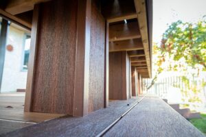 Prestige Woodworks - Christian Neudecker - Deck Builder - 2 Tiered Composite Deck, Double Boarded Fiberon Horizon Line Colour Cinnabar, Main is Fiberon Horizon Line in Colour Ike - Compass is in Fiberon Horizon Line in Colours Tudor Brown and Cinnabar - Border is face screwed and colour matched plugs - Fully Customized Railing System - 4 Custom Staircases - Customized Bench fully Clad in Matching Composite Boarded in Cinnabar to match deck with Covered matching Fascia Boards on Bases