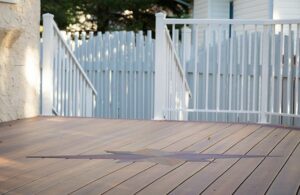 Prestige Woodworks - Christian Neudecker - Deck Builder - 2 Tiered Composite Deck, Double Boarded Fiberon Horizon Line Colour Cinnabar, Main is Fiberon Horizon Line in Colour Ike - Compass is in Fiberon Horizon Line in Colours Tudor Brown and Cinnabar - Border is face screwed and colour matched plugs - Fully Customized Railing System - 4 Custom Staircases - Customized Bench fully Clad in Matching Composite Boarded in Cinnabar to match deck with Covered matching Fascia Boards on Bases